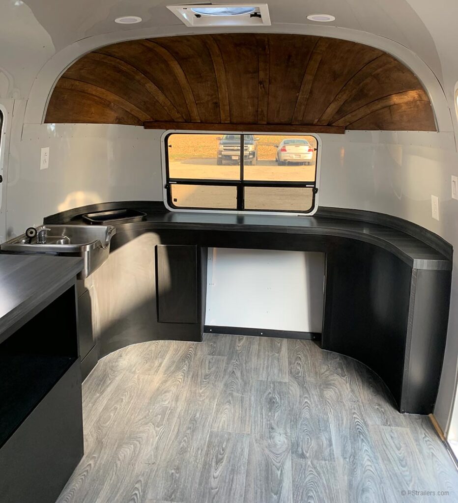 Airstream mobile hair salon interior w/wood wrapped endcap