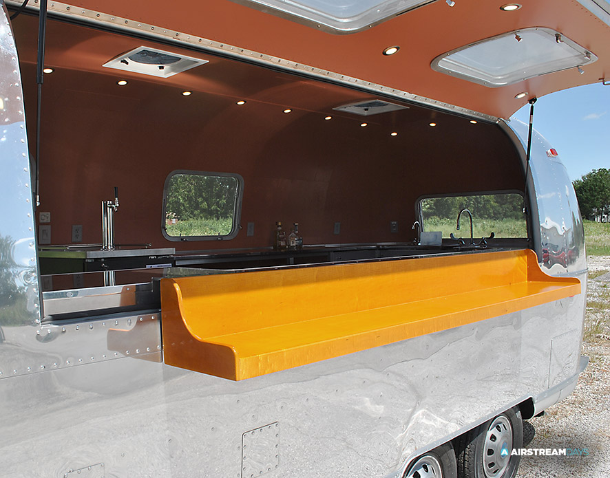 Fold out wood serving shelf on Airstream bar trailer